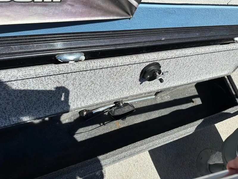 Slide: The Image of 2020 Alumacraft Classic 165 boat interior storage compartment with latch and handle. - 27