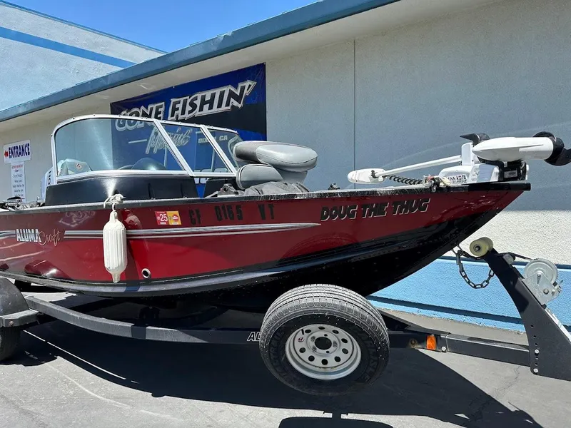 Slide: The Image of 2020 Alumacraft Classic 165 boat on trailer, parked outside a building. - 3