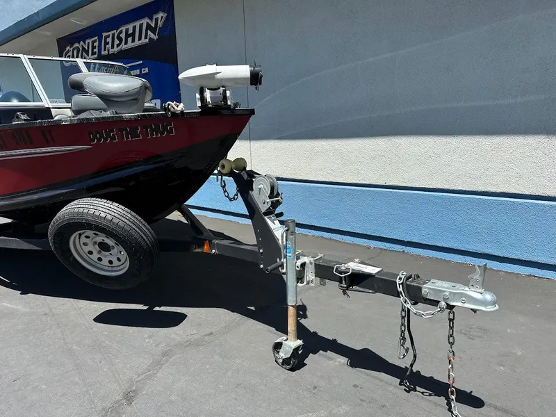 Slide: The Image of 2020 Alumacraft Classic 165 boat on trailer, parked outside a building. - 4