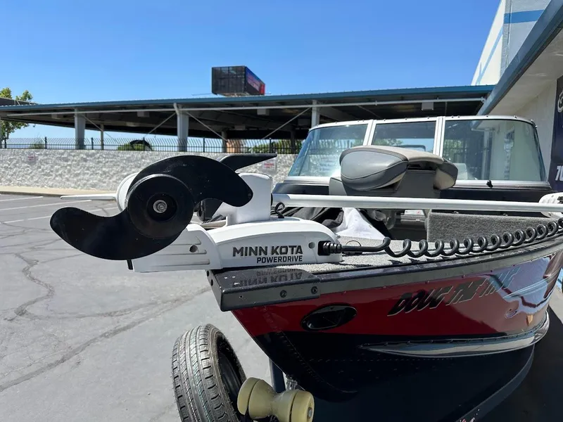 Slide: The Image of 2020 Alumacraft Classic 165 boat with Minn Kota PowerDrive motor in a parking lot. - 6