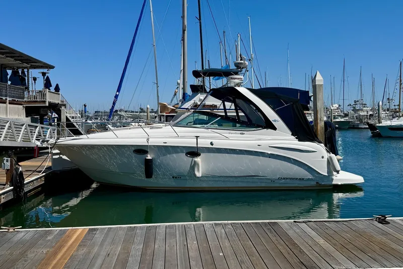 The Image of 2007 Chaparral Signature 310 boat docked at a marina under clear blue skies. - 0