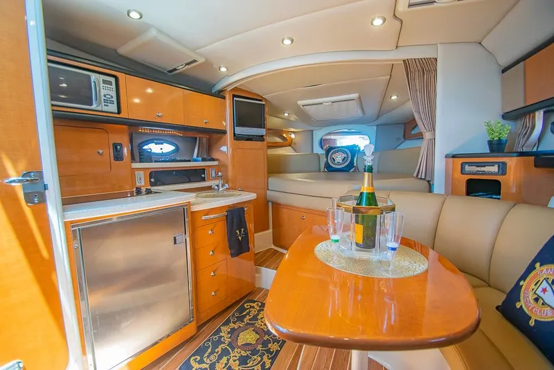 Slide: The Image of Luxurious interior of 2007 Chaparral Signature 310 yacht with kitchen and seating area. - 11