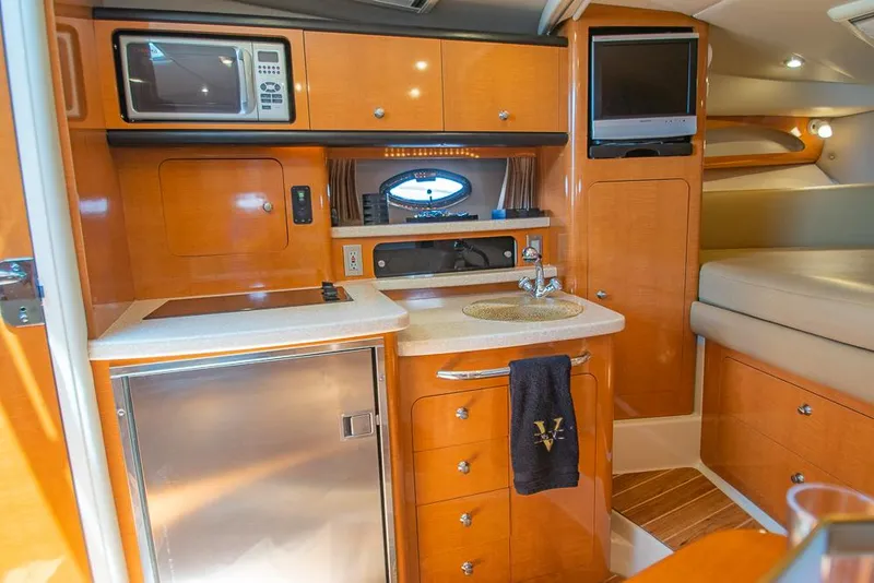 Slide: The Image of 2007 Chaparral Signature 310 yacht interior with kitchenette, microwave, and TV. - 12