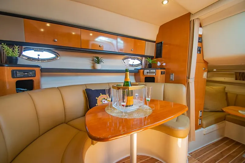 Slide: The Image of Luxurious 2007 Chaparral Signature 310 yacht interior with elegant seating and champagne on the table. - 16