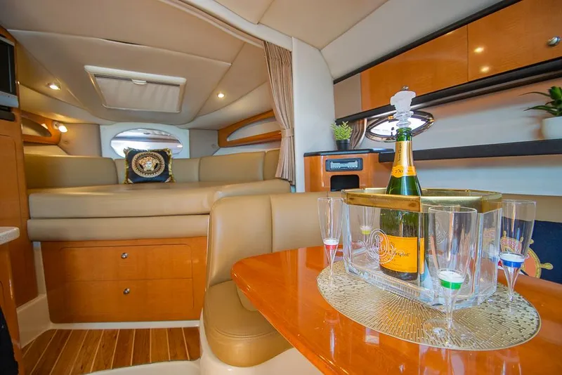 Slide: The Image of 2007 Chaparral Signature 310 interior with champagne and glasses on a wooden table. - 17