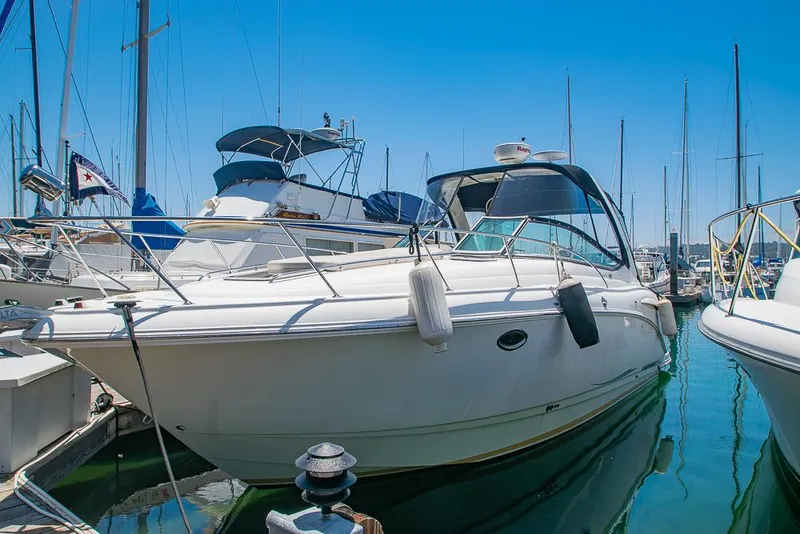 Slide: The Image of 2007 Chaparral Signature 310 yacht docked in a marina under clear blue skies. - 2