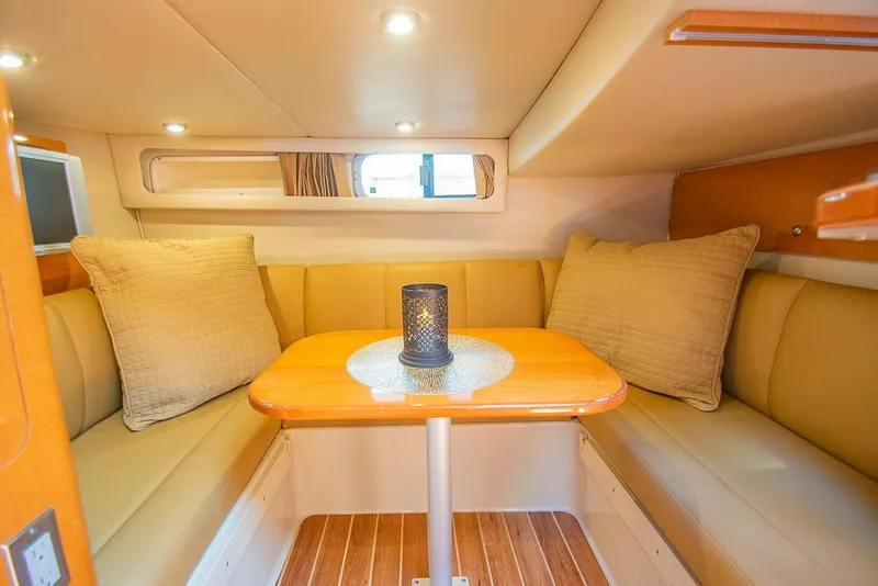 Slide: The Image of 2007 Chaparral Signature 310 cabin interior with cozy seating and table. - 22