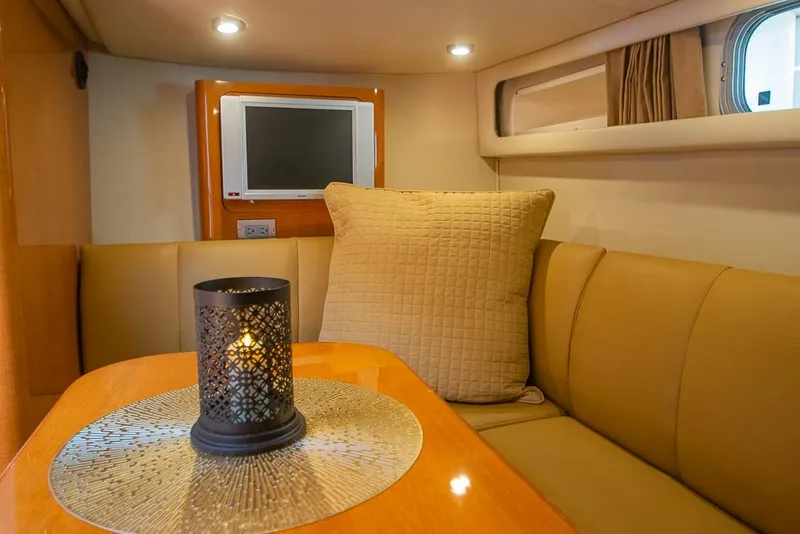 Slide: The Image of 2007 Chaparral Signature 310 interior with cozy seating, candle, and TV. - 23