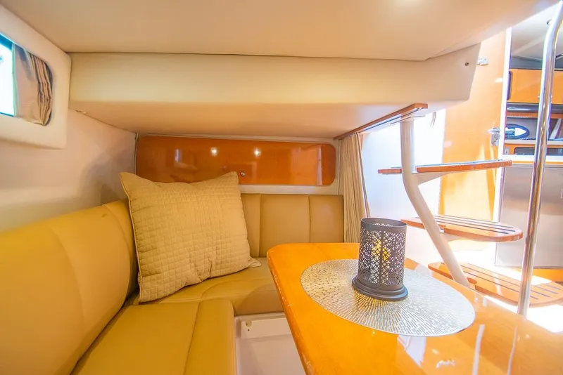 Slide: The Image of 2007 Chaparral Signature 310 cabin interior with cozy seating and elegant wooden table. - 24