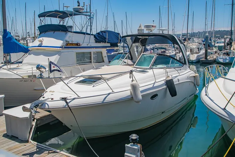 Slide: The Image of 2007 Chaparral Signature 310 boat docked in a marina, surrounded by other vessels. - 3