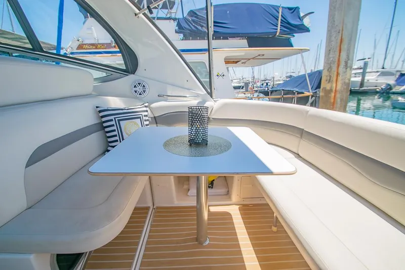 Slide: The Image of 2007 Chaparral Signature 310 yacht interior with seating and table in a marina setting. - 32
