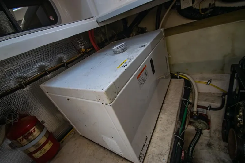 Slide: The Image of Engine room of 2007 Chaparral Signature 310 with generator and fire extinguisher. - 43