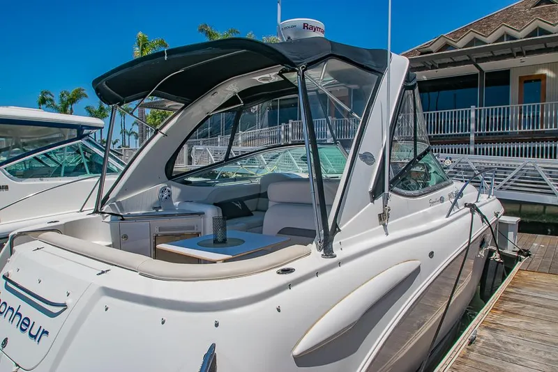 Slide: The Image of 2007 Chaparral Signature 310 boat docked at marina, featuring sleek design and covered cockpit. - 6
