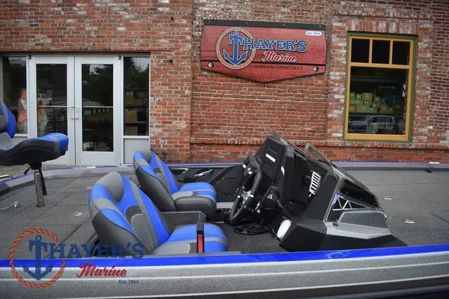 Slide: The Image of 2021 Ranger Z521L boat with blue seats at Thayer's Marine storefront. - 12