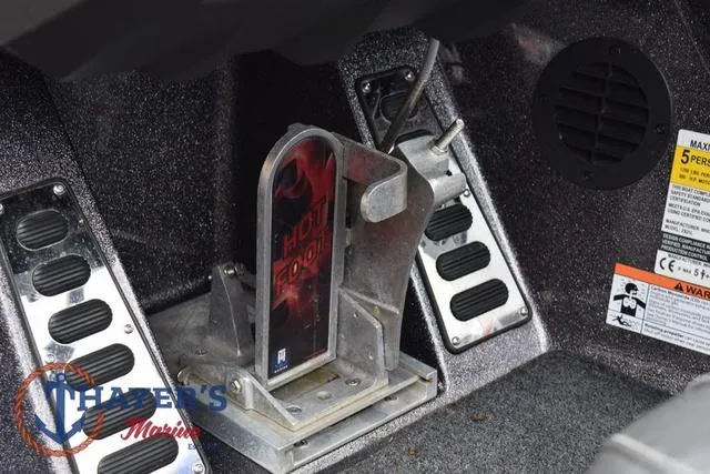 Slide: The Image of 2021 Ranger Z521L boat foot pedal and control panel with warning labels. - 18