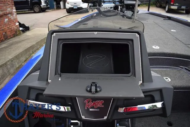 Slide: The Image of 2021 Ranger Z521L boat dashboard with open storage compartment, featuring Ranger logo. - 22