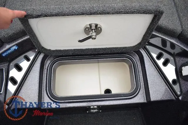 Slide: The Image of 2021 Ranger Z521L boat storage compartment with open lid, featuring Thayer's Marine logo. - 26