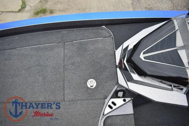 Slide: The Image of 2021 Ranger Z521L boat deck with Thayer's Marine logo, featuring sleek design and carpeted surface. - 33