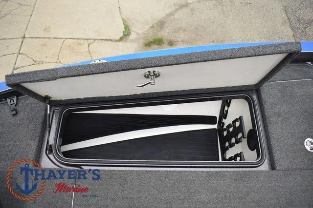 Slide: The Image of Open storage compartment on 2021 Ranger Z521L boat, featuring Thayer's Marine logo. - 36