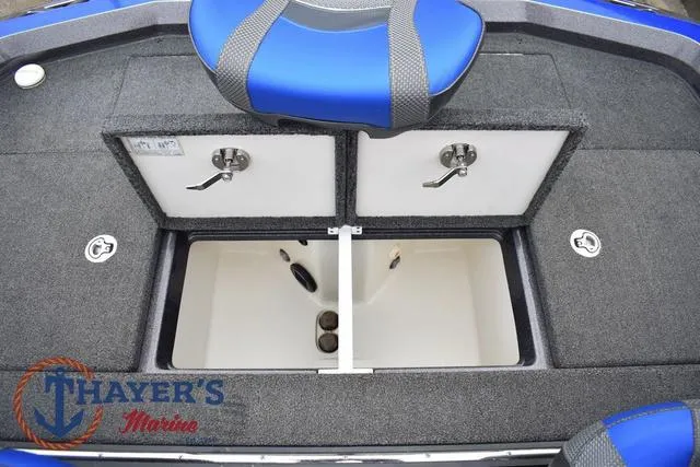 Slide: The Image of 2021 Ranger Z521L boat storage compartments with blue seat, Thayer's Marine logo visible. - 45