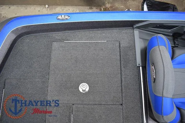 Slide: The Image of 2021 Ranger Z521L boat interior with blue and gray seating, Thayer's Marine logo visible. - 48
