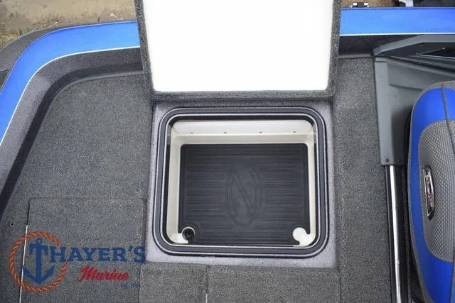 Slide: The Image of Open storage compartment on a 2021 Ranger Z521L boat, featuring Thayer's Marine logo. - 49