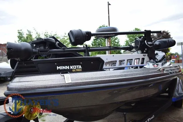 Slide: The Image of 2021 Ranger Z521L boat with Minn Kota Ultrex trolling motor, displayed outdoors. - 8