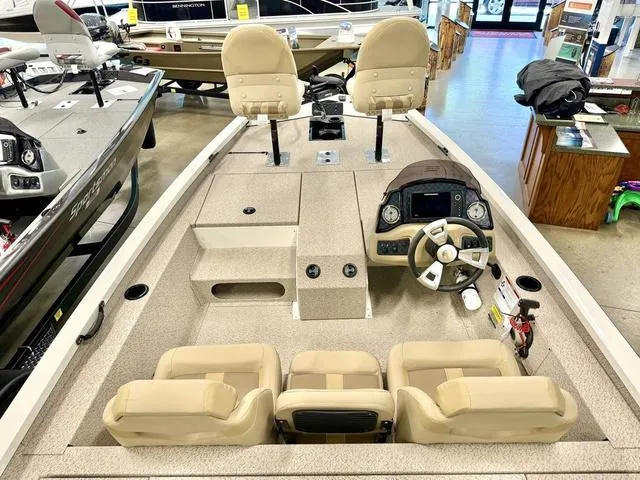 Slide: The Image of 2025 G3 Sportsman 1710 boat interior with beige seating and modern dashboard. - 2