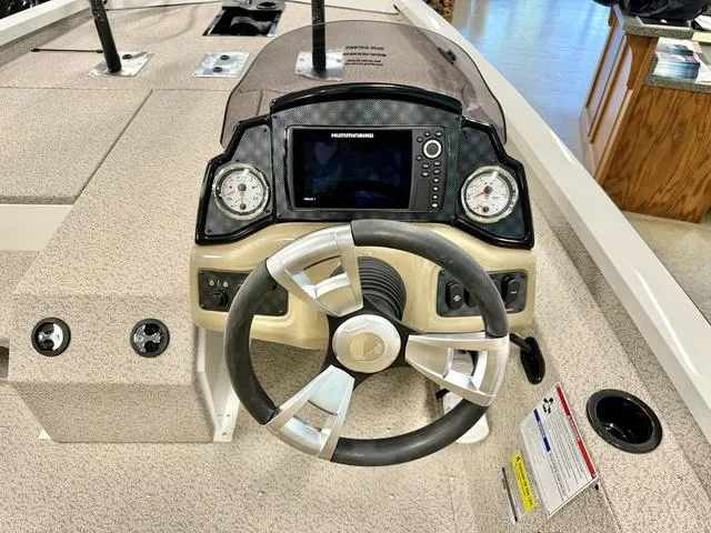 Slide: The Image of 2025 G3 Sportsman 1710 boat dashboard with steering wheel and navigation system. - 4