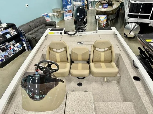 Slide: The Image of 2025 G3 Sportsman 1710 boat interior with beige seating and steering console. - 6
