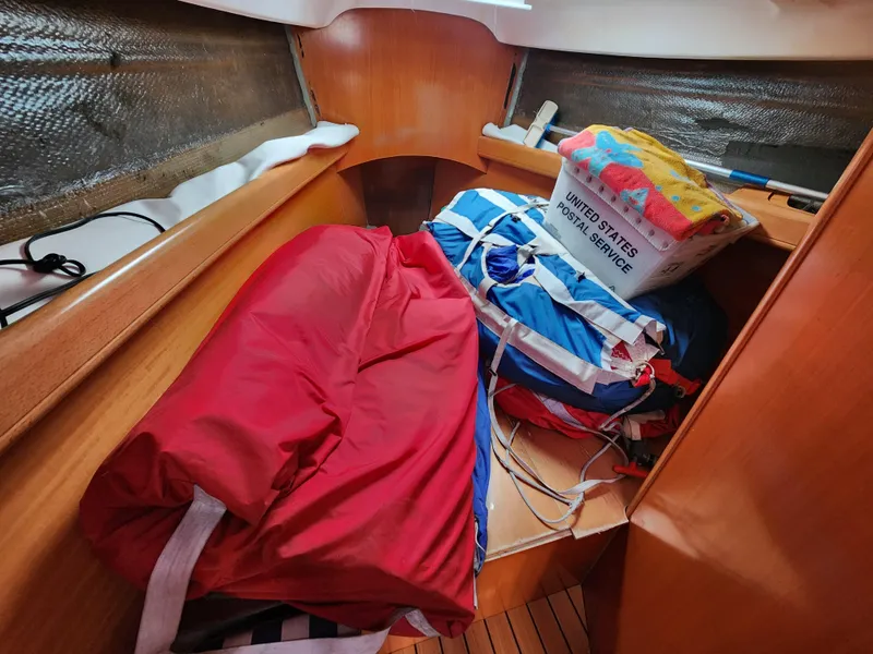 Slide: The Image of Interior of 2003 Beneteau First 40.7 sailboat with colorful sails and storage items. - 18