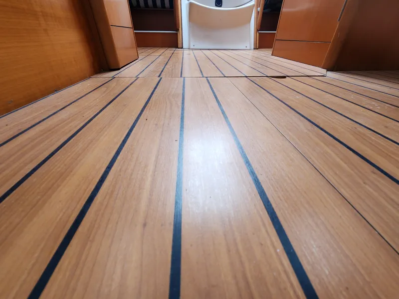 Slide: The Image of Teak flooring inside a 2003 Beneteau First 40.7 sailboat cabin. - 22