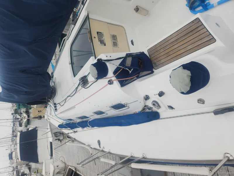 Slide: The Image of Beneteau First 40.7 sailboat deck, 2003 model, docked with blue covers and equipment. - 4