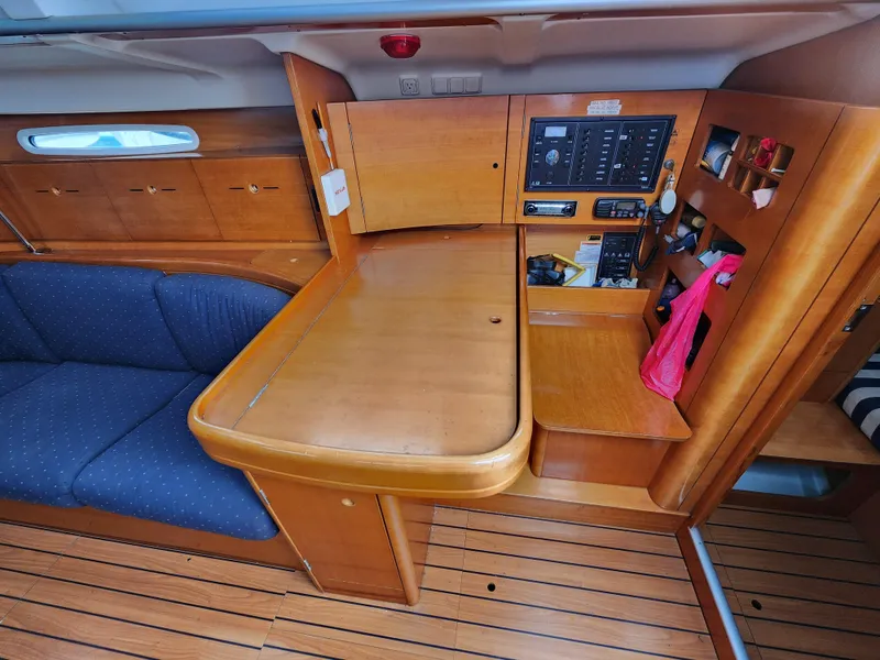 Slide: The Image of Interior of 2003 Beneteau First 40.7 yacht with wooden cabinetry and navigation station. - 7