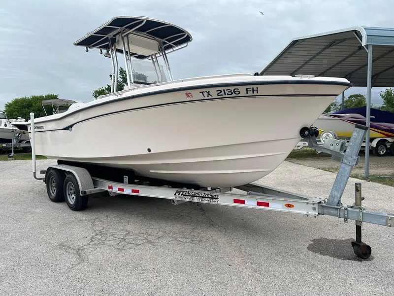 Slide: The Image of 1999 Grady-White 222 boat on trailer, parked outdoors under cloudy sky. - 0