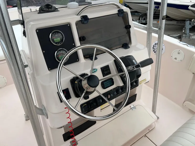 Slide: The Image of 1999 Grady-White 222 boat dashboard with steering wheel and control panel. - 10