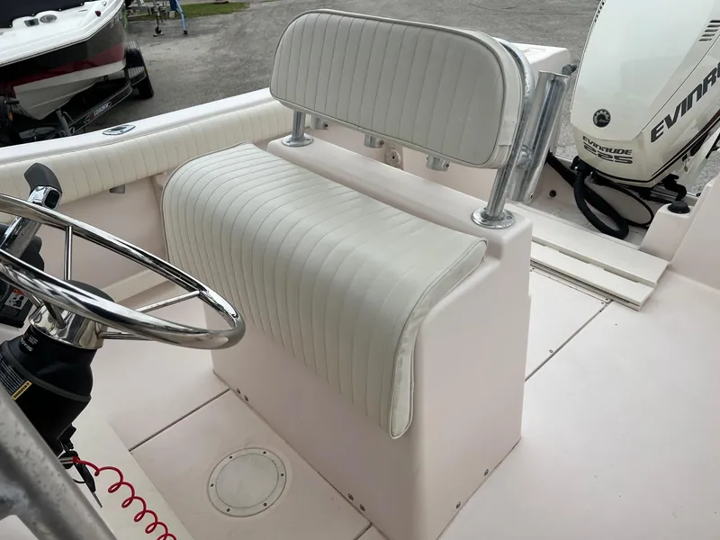 Slide: The Image of 1999 Grady-White 222 boat interior with white seating and steering wheel. - 11