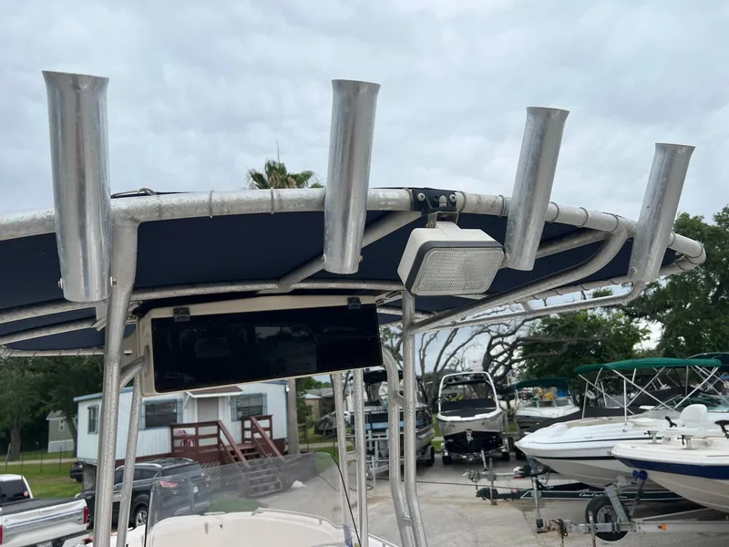 Slide: The Image of 1999 Grady-White 222 boat with T-top and rod holders in a marina setting. - 12