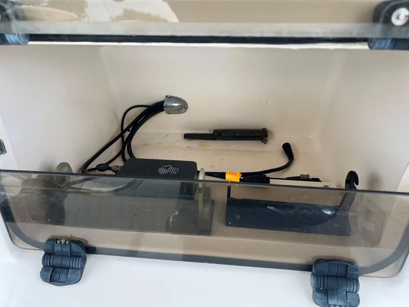 Slide: The Image of Storage compartment of a 1999 Grady-White 222 boat with cables and equipment. - 14