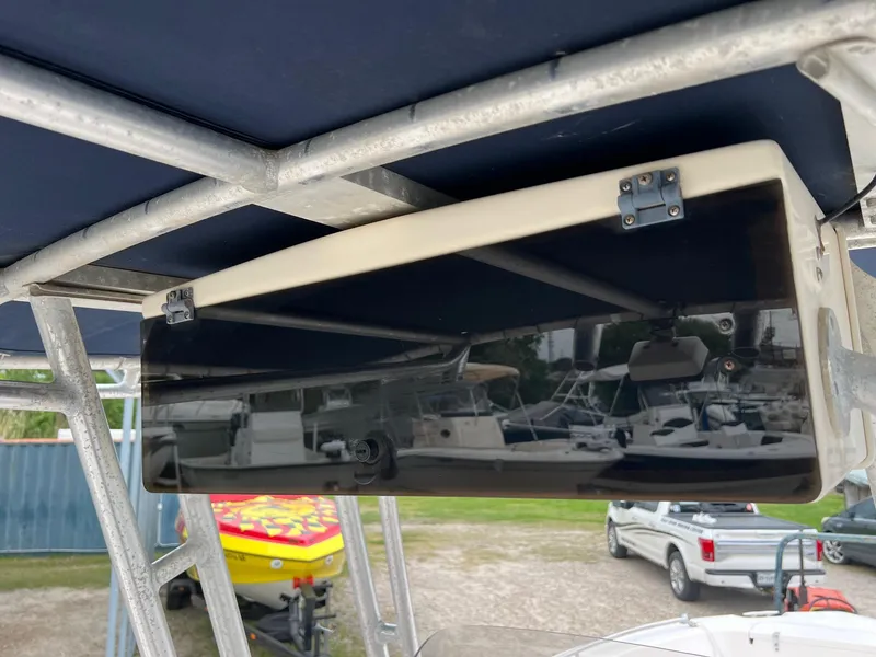 Slide: The Image of 1999 Grady-White 222 boat with T-top and storage compartment, docked near other boats. - 15