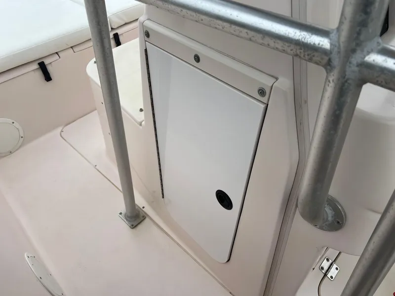 Slide: The Image of 1999 Grady-White 222 boat interior with storage compartment and railing. - 17