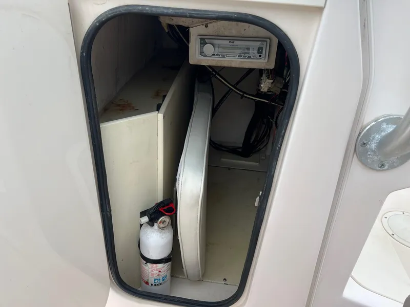 Slide: The Image of Storage compartment in a 1999 Grady-White 222 boat with fire extinguisher and equipment. - 18