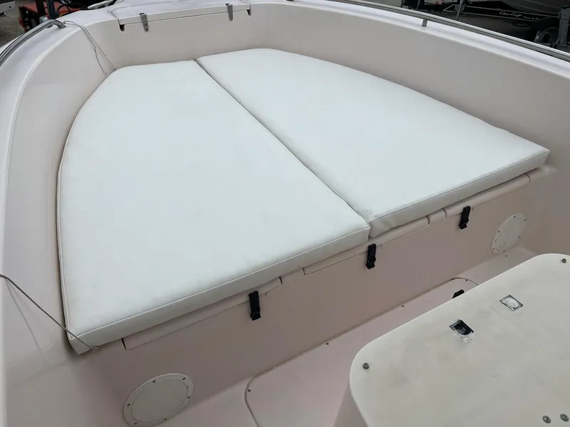 Slide: The Image of 1999 Grady-White 222 boat with cushioned seating area. - 19