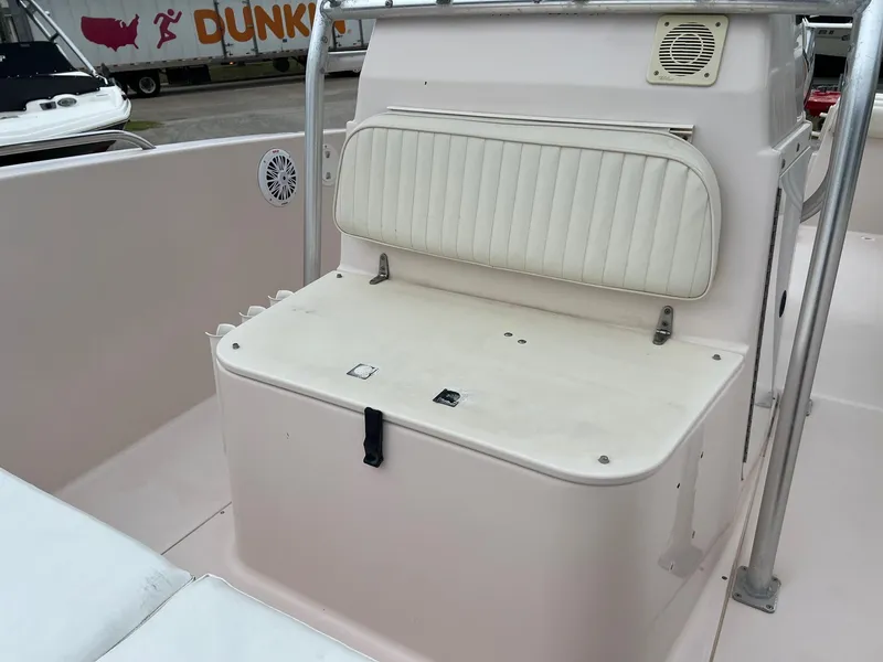 Slide: The Image of 1999 Grady-White 222 boat interior with white seating and storage compartment. - 20