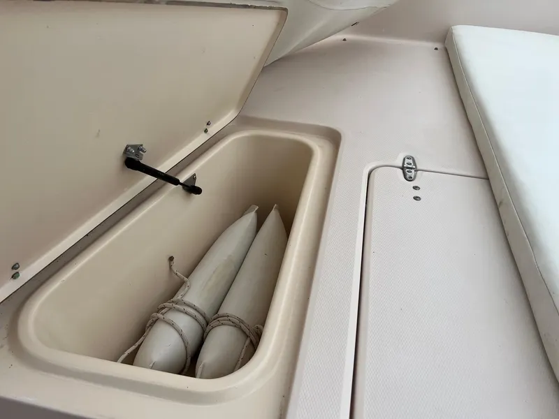 Slide: The Image of Open storage compartment on 1999 Grady-White 222 boat with fenders inside. - 22