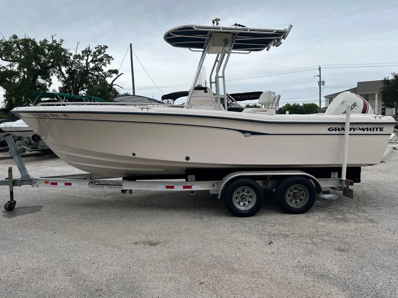 Slide: The Image of 1999 Grady-White 222 boat on trailer, side view, parked outdoors. - 27