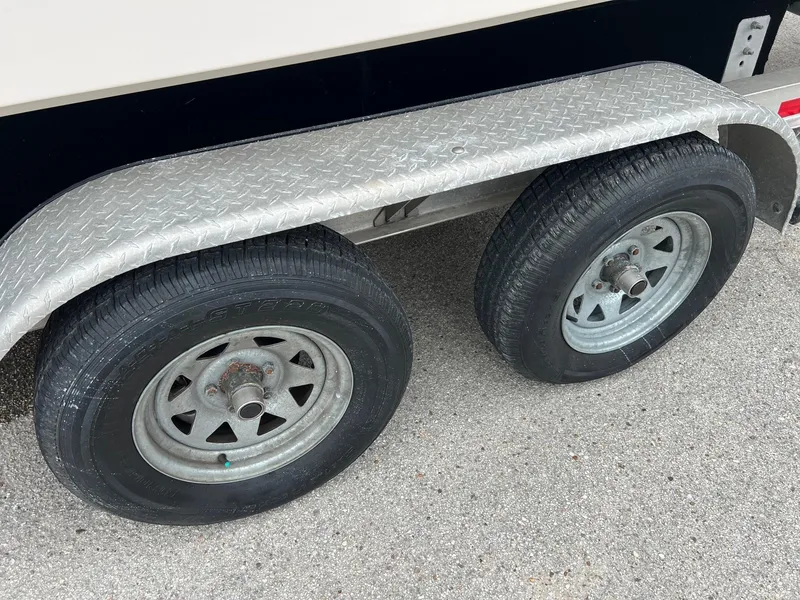 Slide: The Image of Trailer wheels of a 1999 Grady-White 222 boat on pavement. - 28