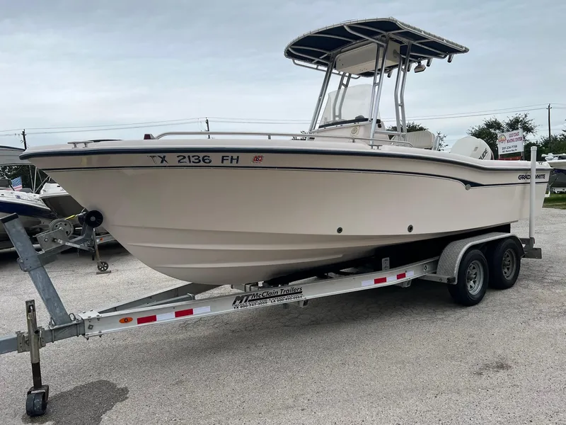 Slide: The Image of 1999 Grady-White 222 boat on trailer, side view, parked outdoors. - 29