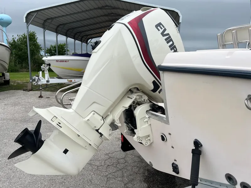 Slide: The Image of 1999 Grady-White 222 boat with Evinrude outboard motor in a marina setting. - 3
