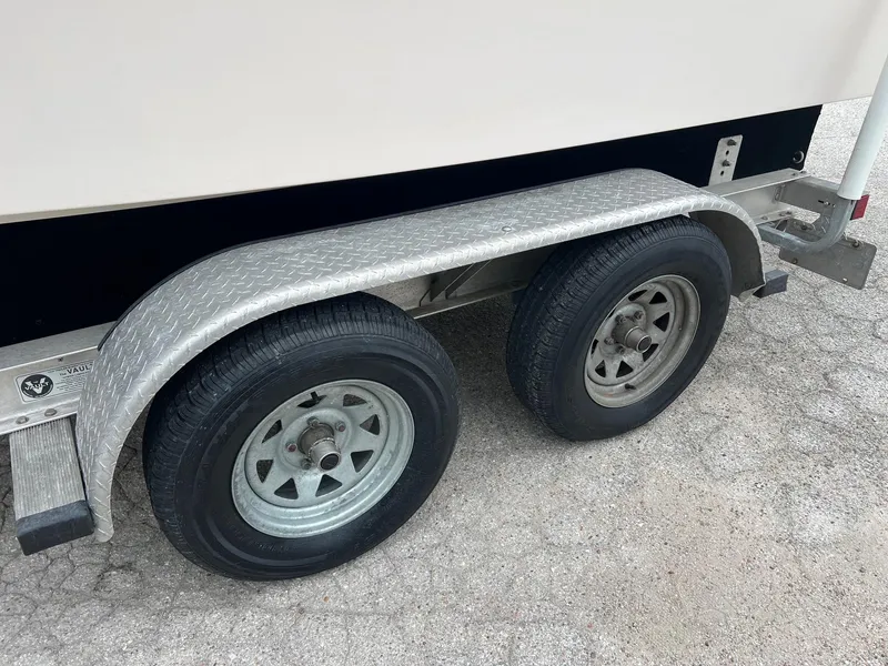 Slide: The Image of Trailer wheels of a 1999 Grady-White 222 boat on a textured surface. - 30